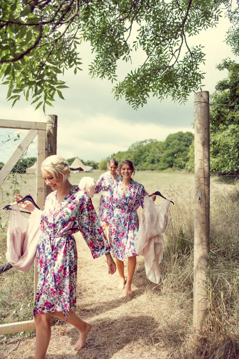 Bridesmaids with Wedding Tipi / Marquee in background
