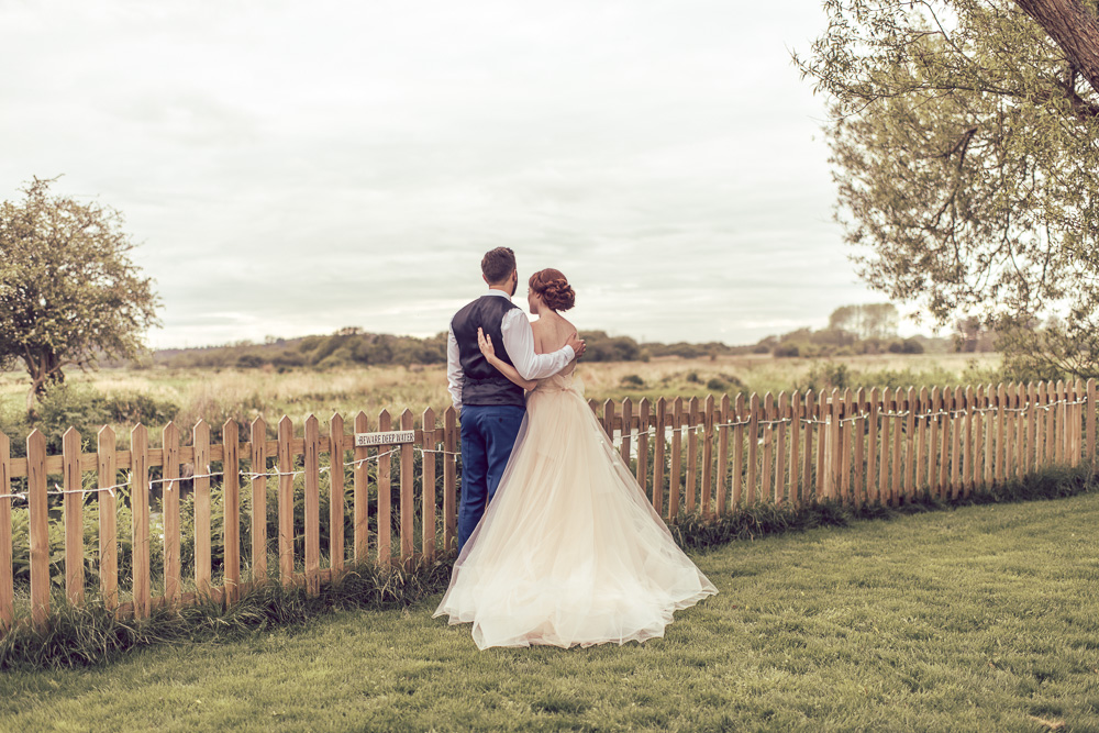 Bride & Groom by the river at Sopley Mill
