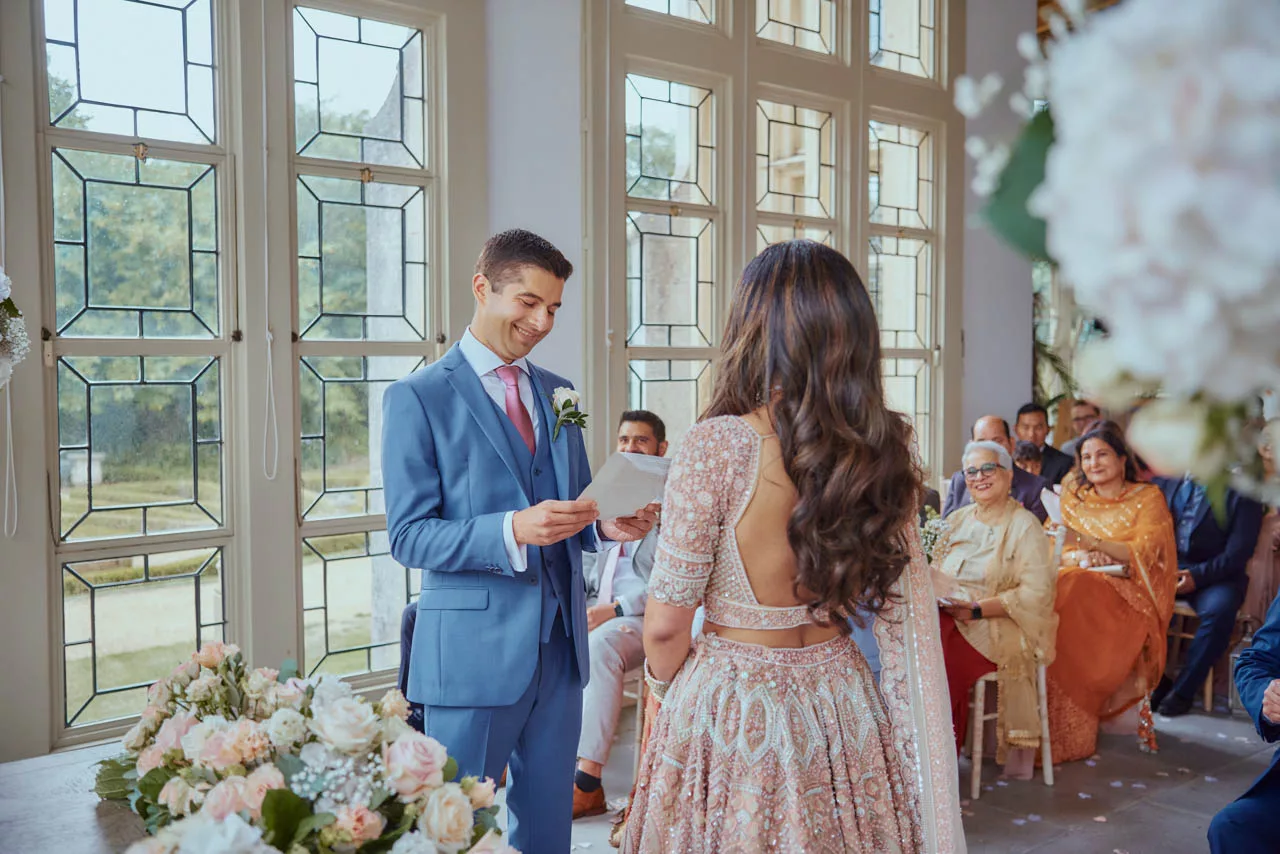 Bride & Groom say vows during Indian Fusion Wedding ceremony at Highcliffe Castle in Dorset