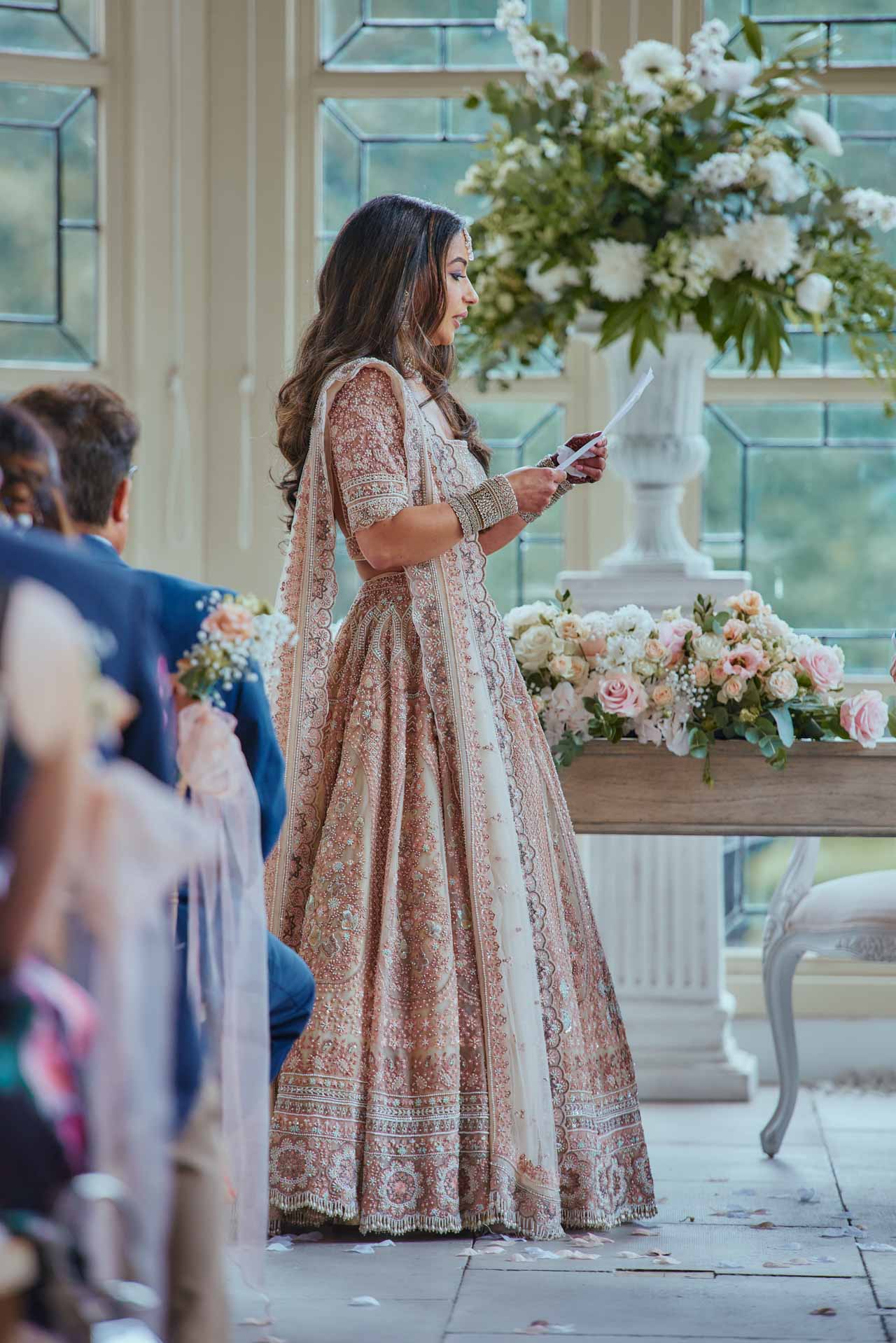 Bride saying her vows during Indian Fusion Wedding ceremony at Highcliffe Castle in Dorset