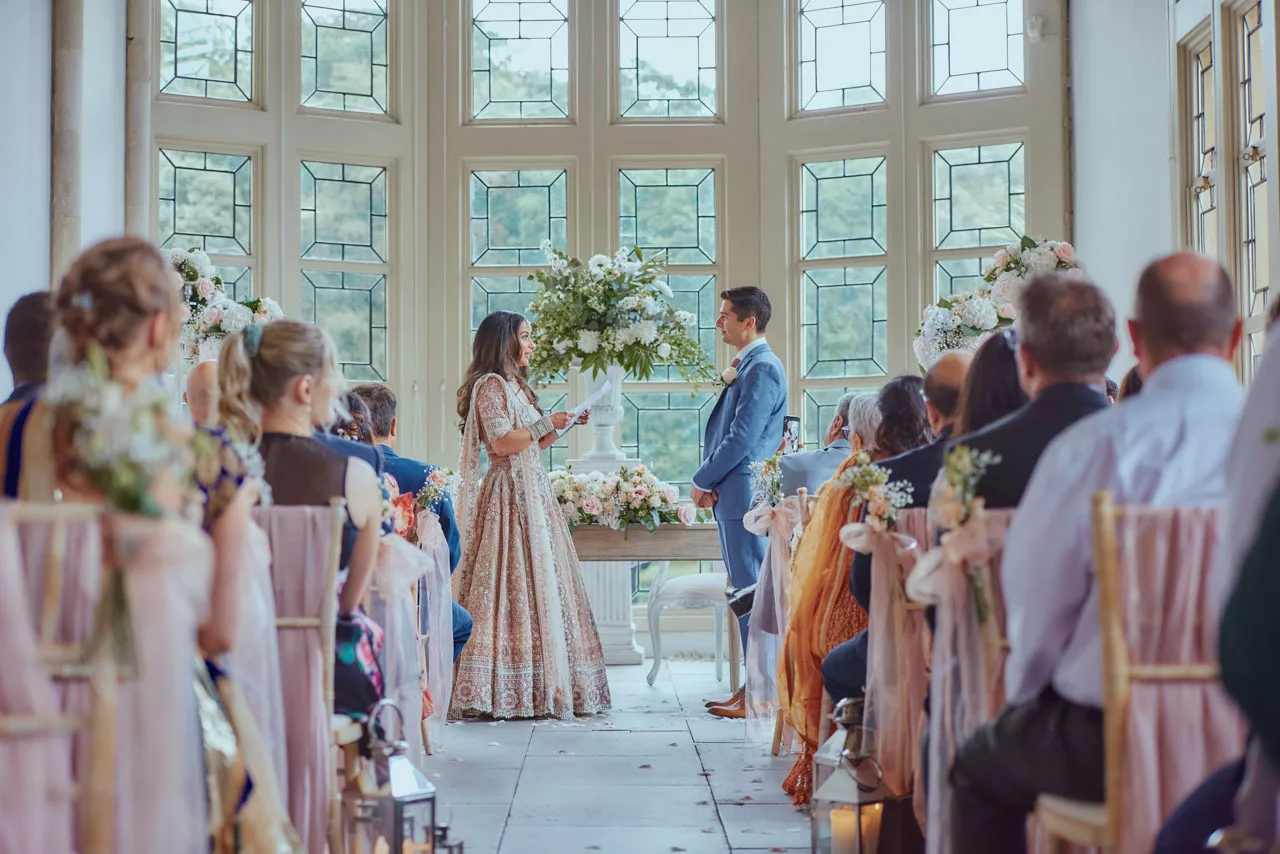 Bride & Groom say vows during Indian Fusion Wedding ceremony at Highcliffe Castle in Dorset