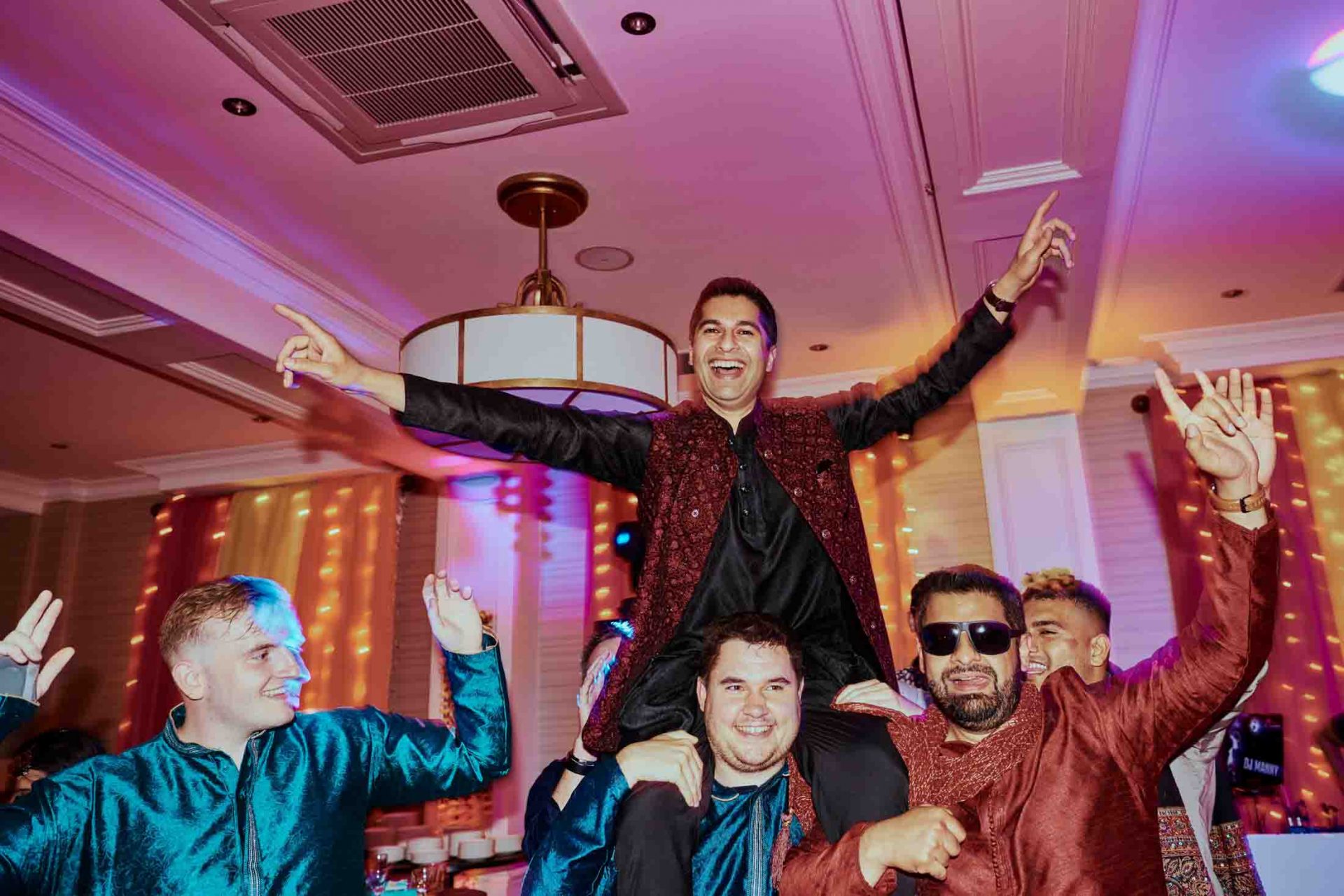 Groom celebrating during a Sangeet in Dorset
