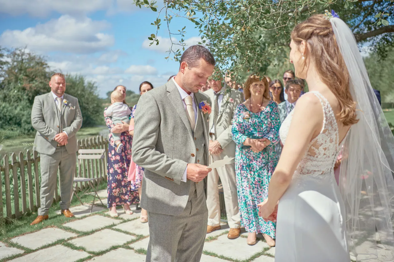 Bride and groom during an outdoor wedding ceremony at Sopley Mill