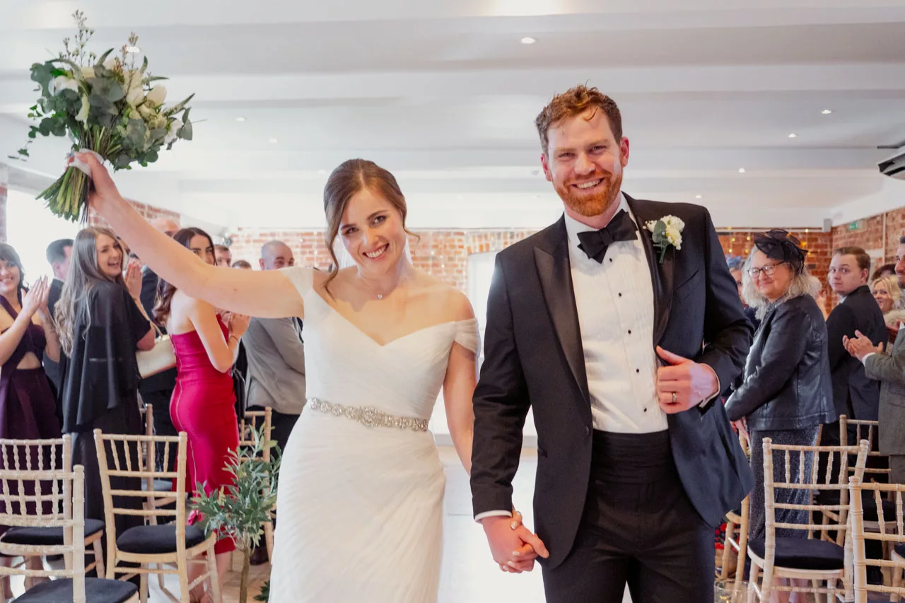 Bride & Groom celebrate during an inside ceremony at Sopley Mill