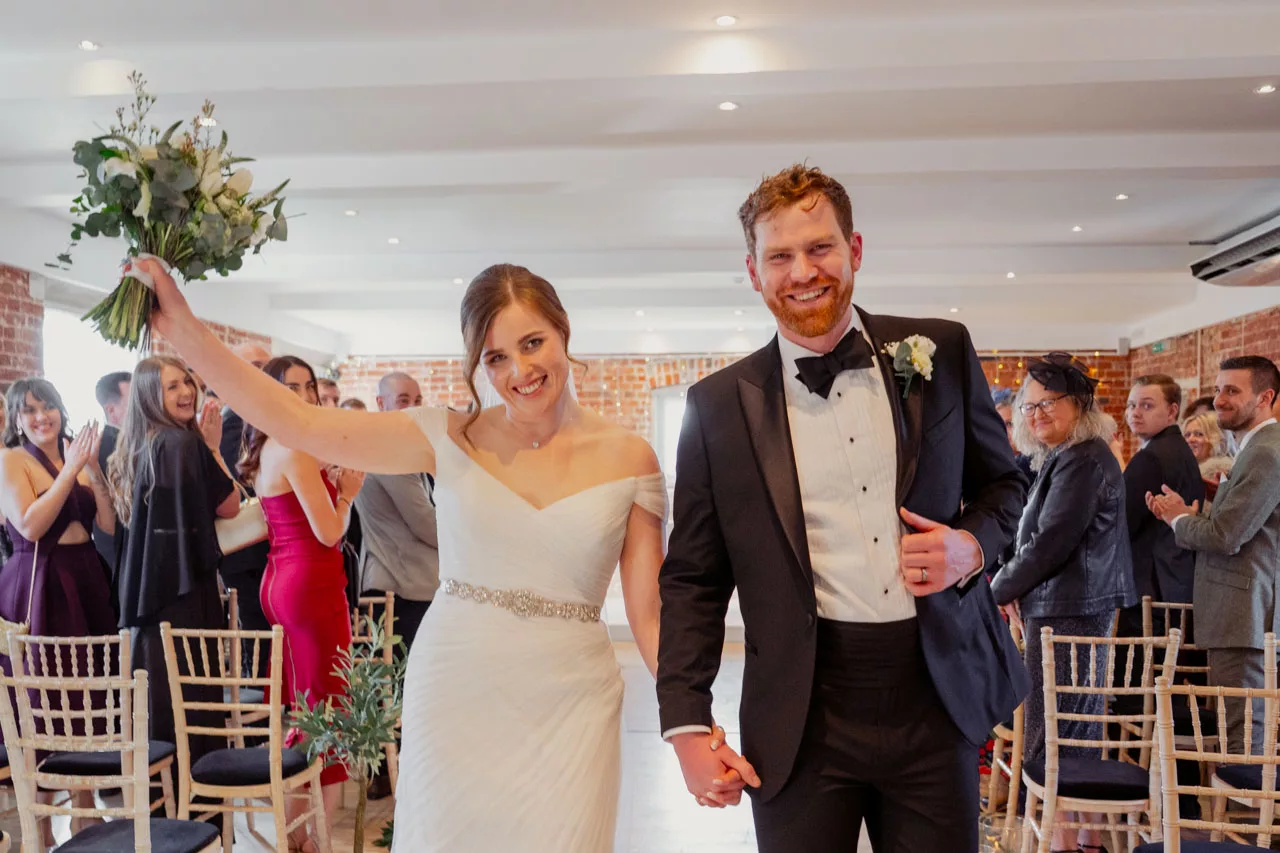Bride & Groom celebrate during an inside ceremony at Sopley Mill