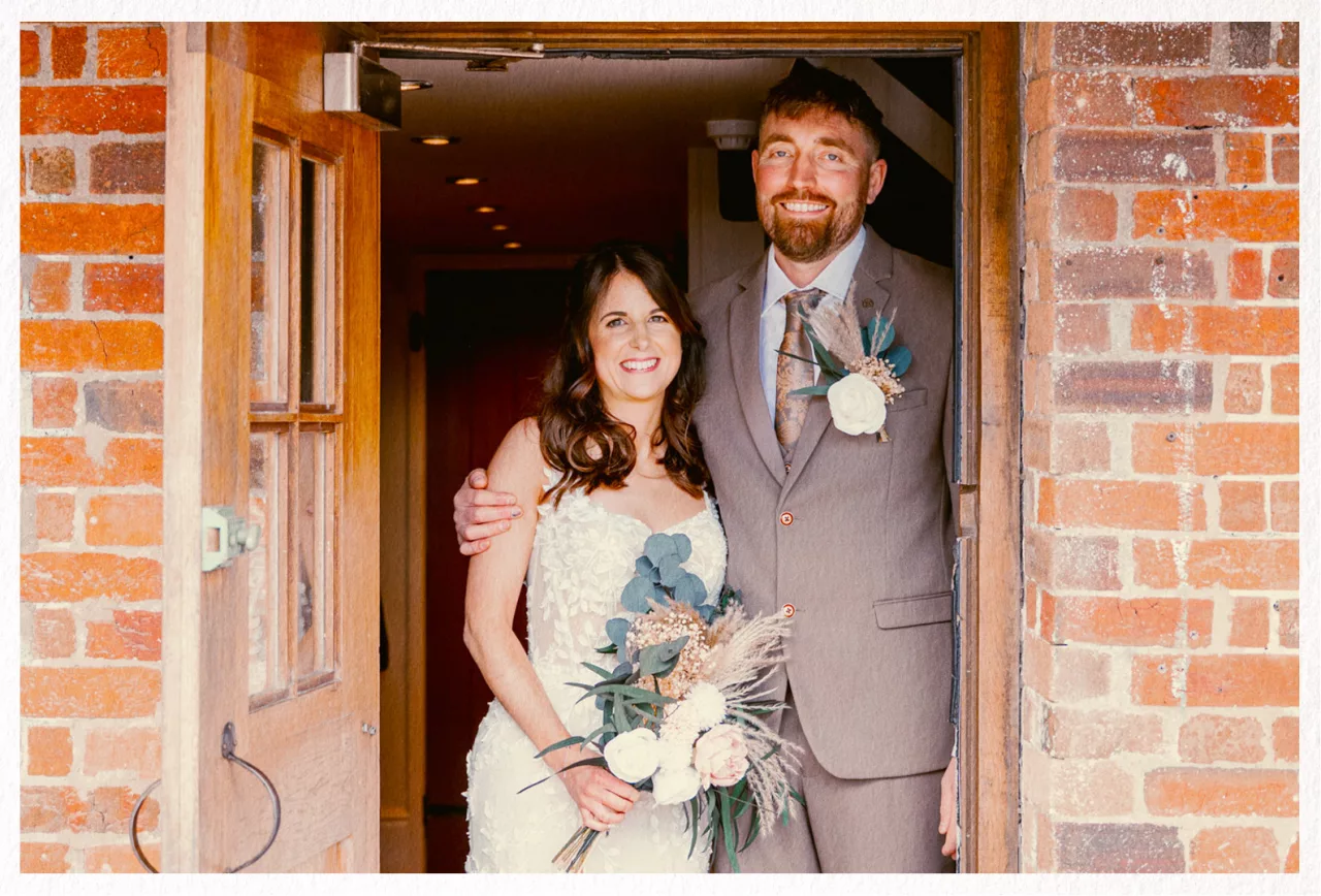 Bride & Groom in the doorway at Sopley Mill after their wedding