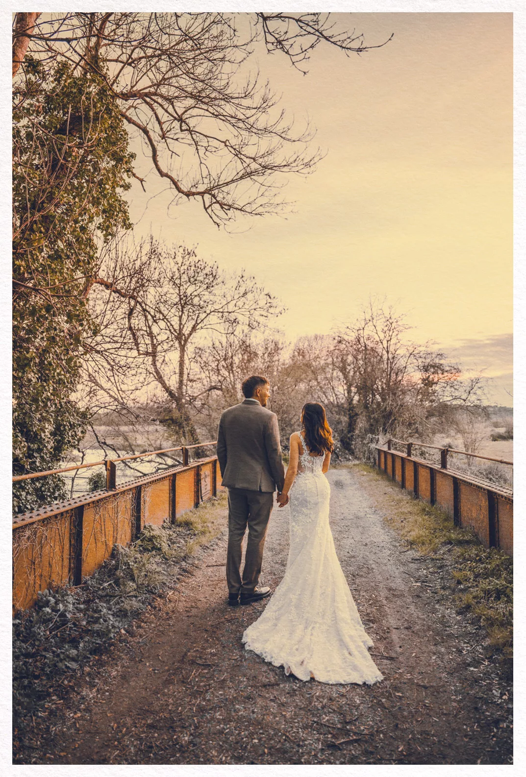 Beautiful sunset image of Bride & Groom on the bridge at Sopley Mill