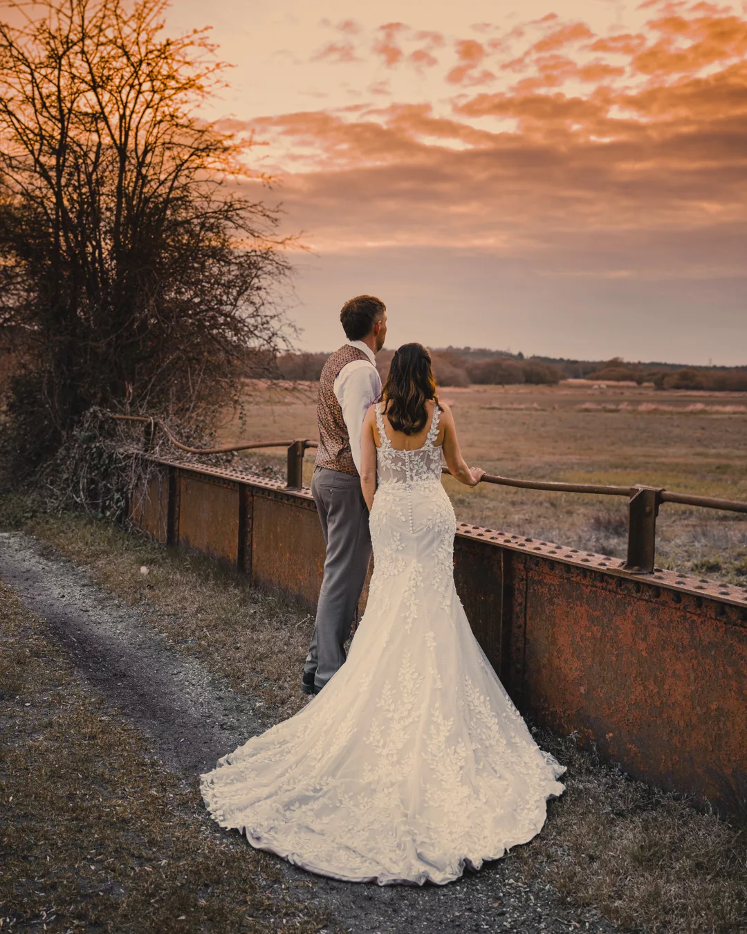 Bride and groom on the bridge of Sopley mill during a Spring wedding