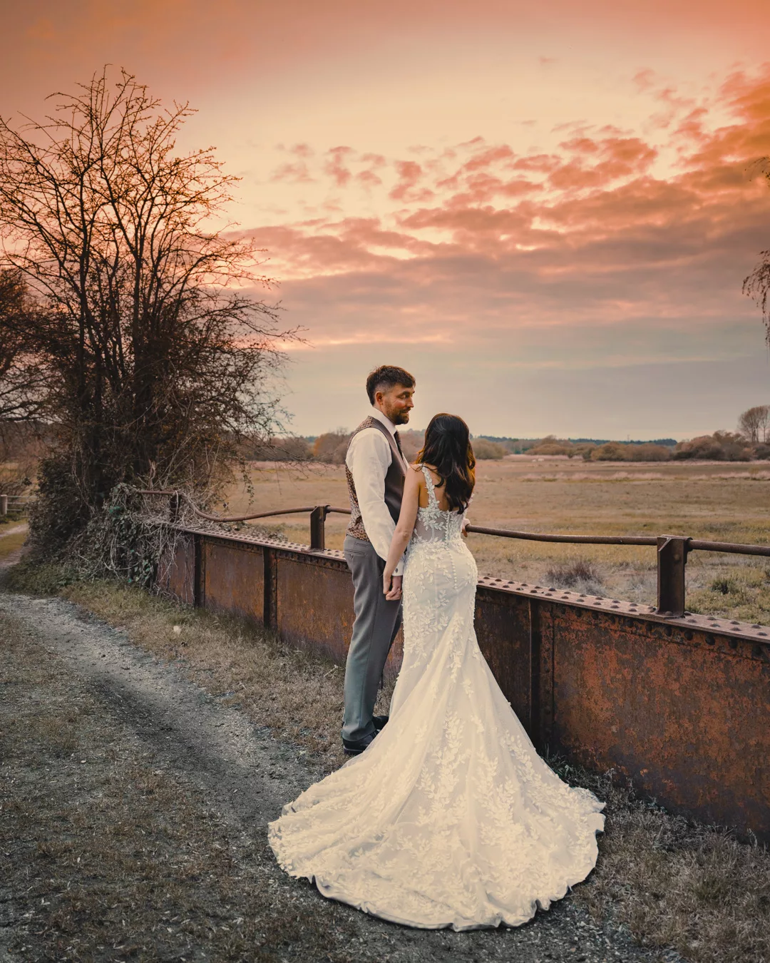 Bride and groom on the bridge of Sopley mill during a Spring wedding