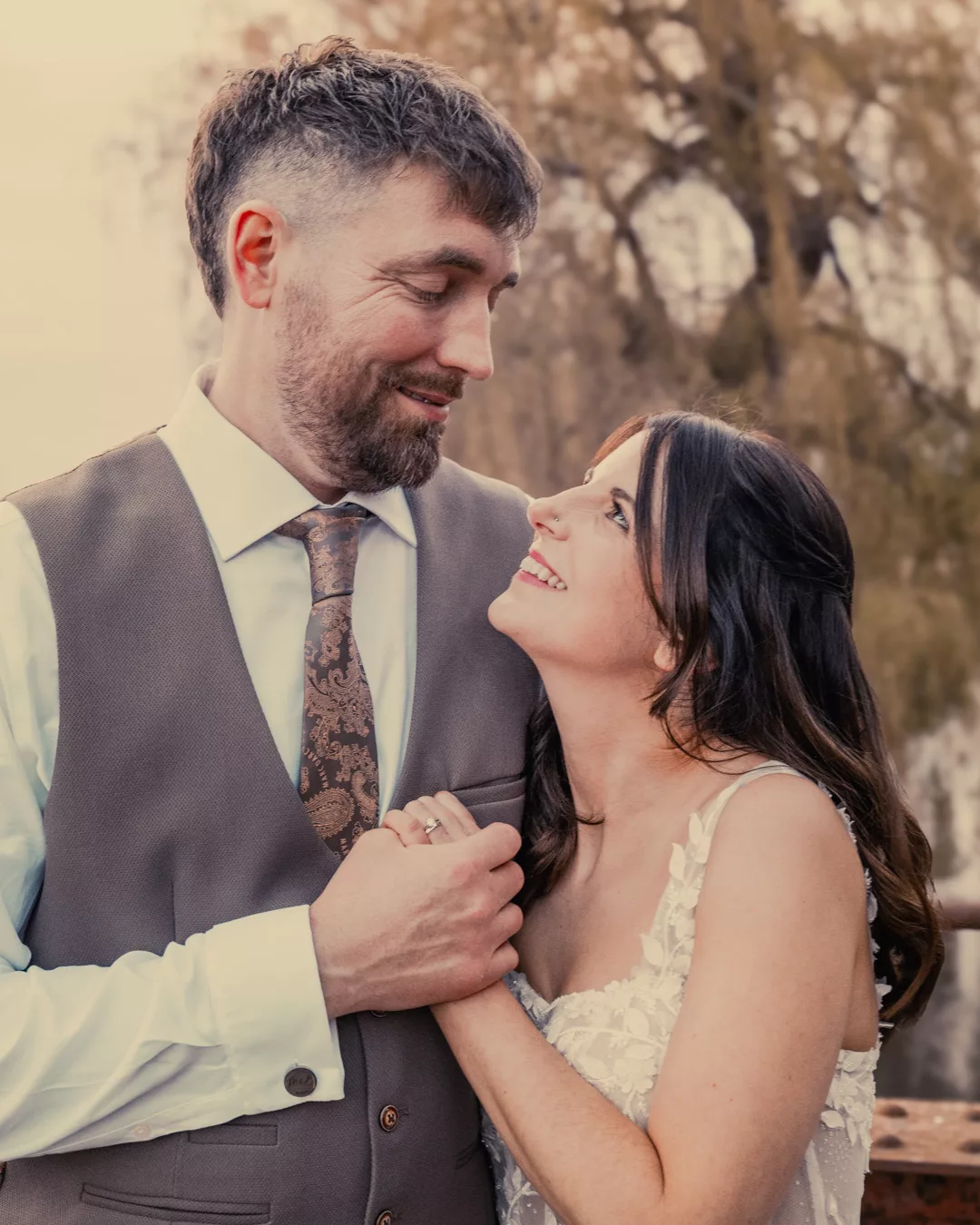 Bride and groom on the bridge of Sopley mill during a Spring wedding