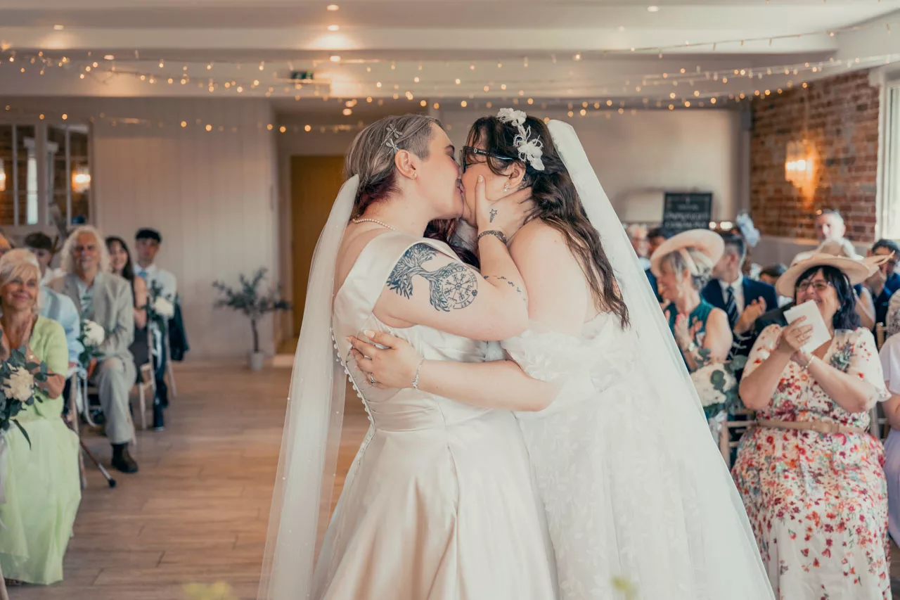 Two Brides wedding ceremony inside at Sopley mill