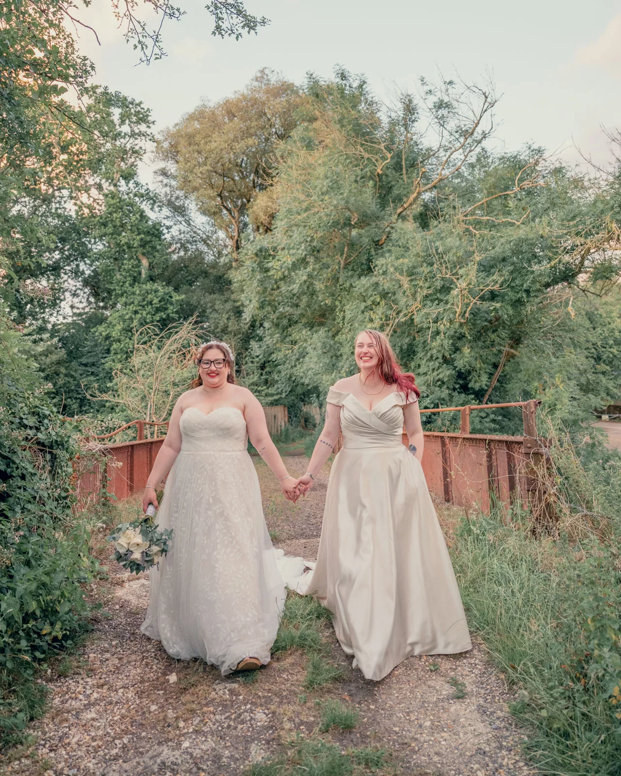 Two Brides on the bridge after their wedding at Sopley Mill 