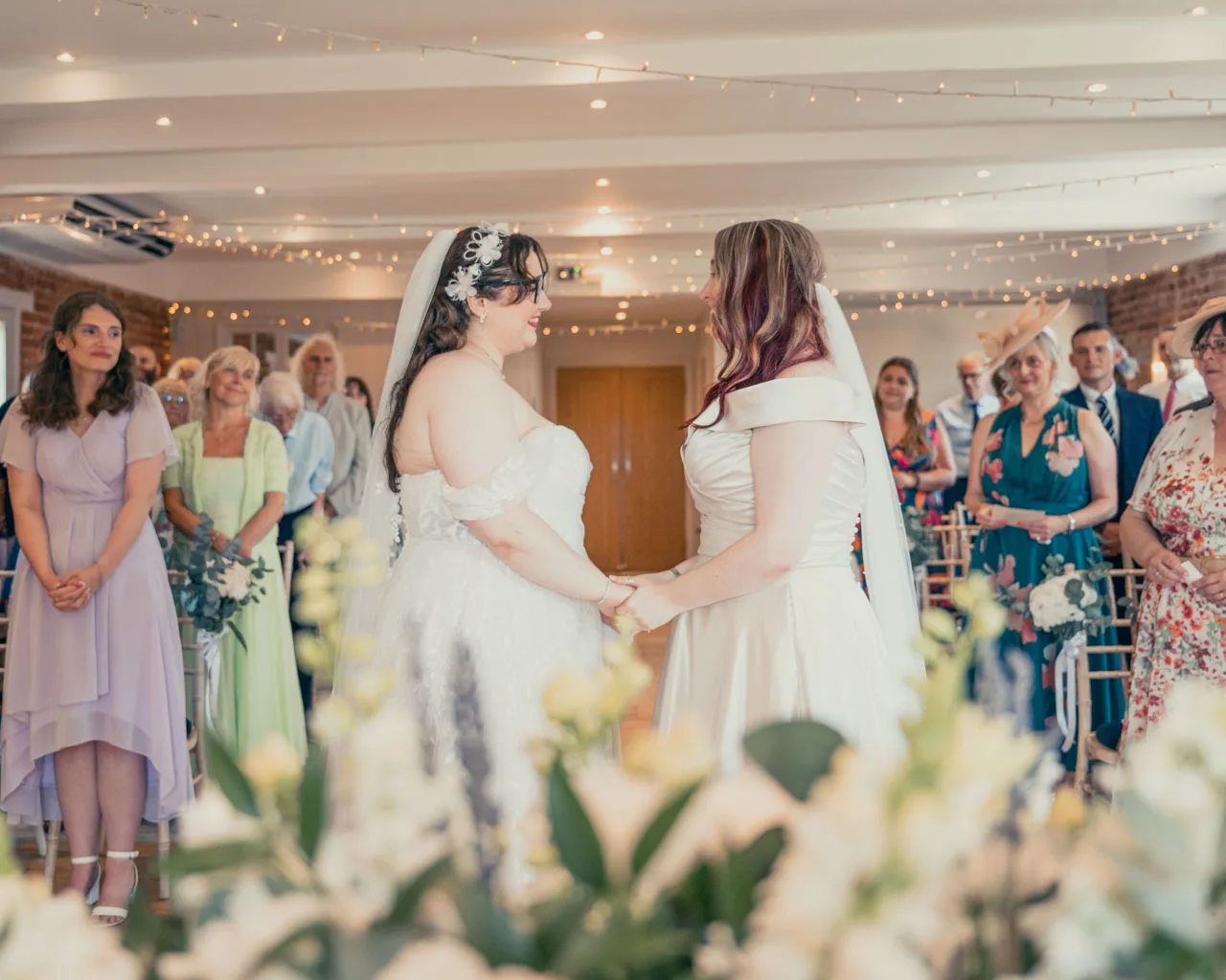 Two Brides wedding ceremony inside at Sopley mill