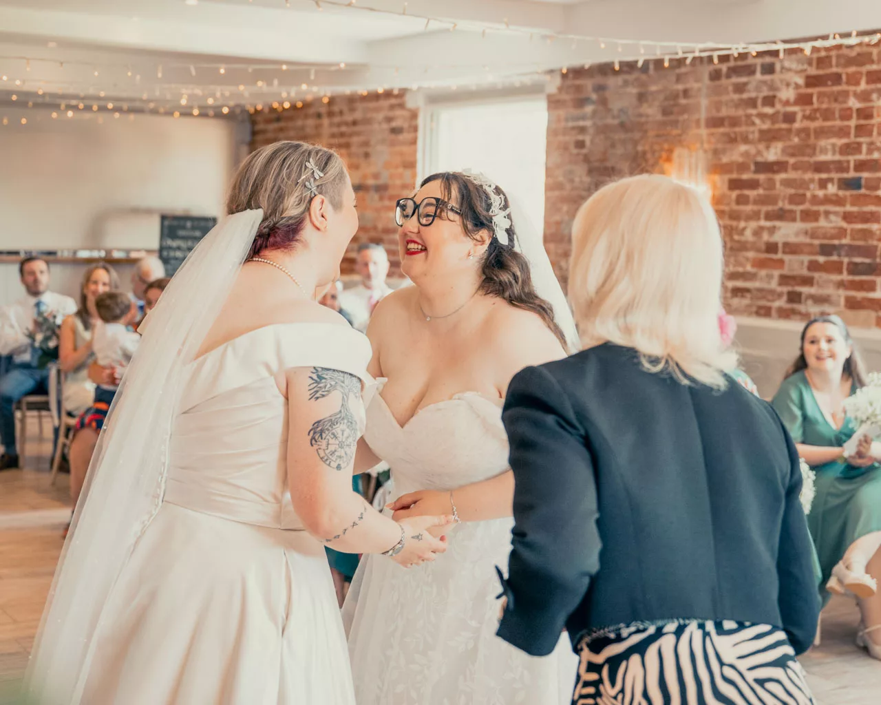 Two Brides wedding ceremony inside at Sopley mill