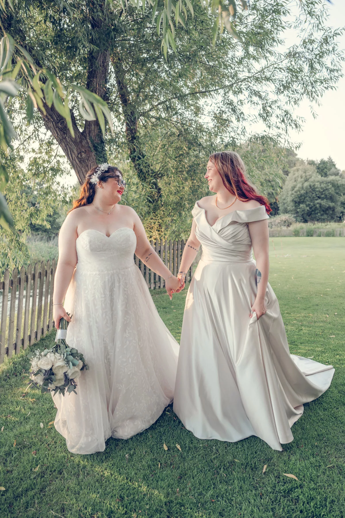 Two Brides Walking in the grounds after their wedding ceremony at Sopley mill