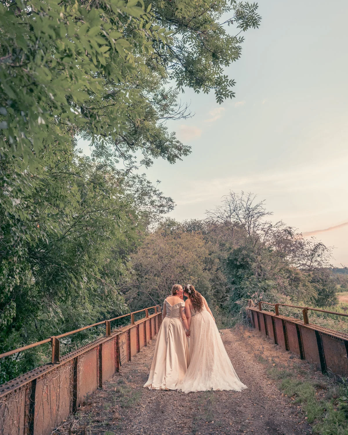 Two Brides on the bridge at Sopley Mill at sunset