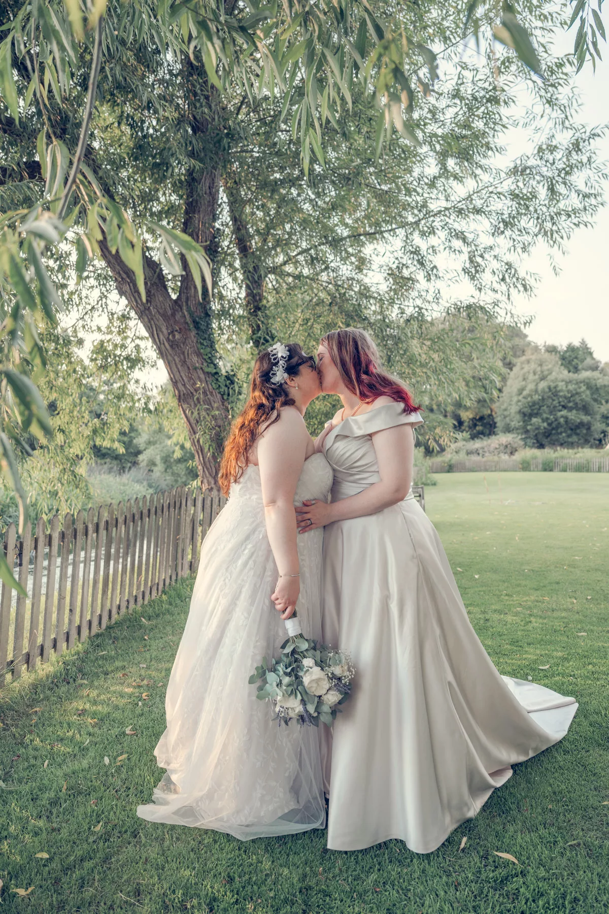 Two Brides in the grounds after their wedding ceremony at Sopley mill