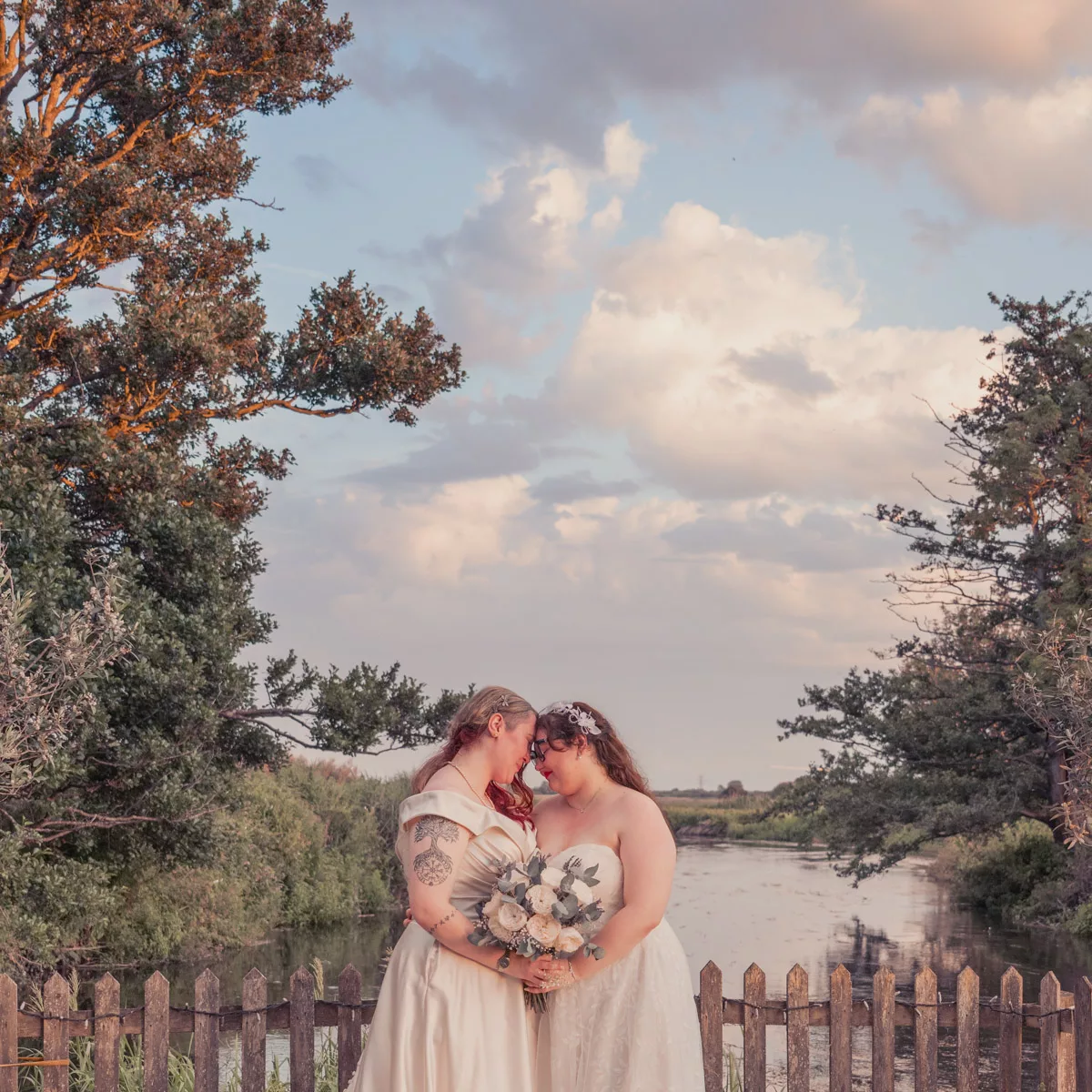 Two Brides in the outside wedding area under the trees at Sopley Mill