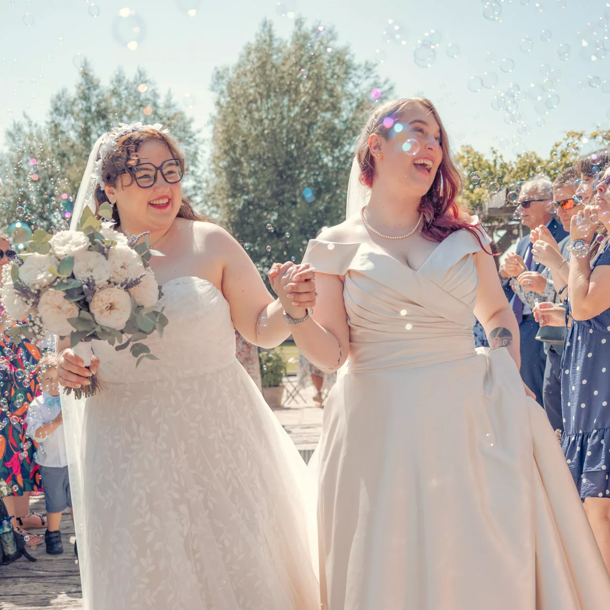 Two Brides with bubble confetti after their wedding at Sopley mill