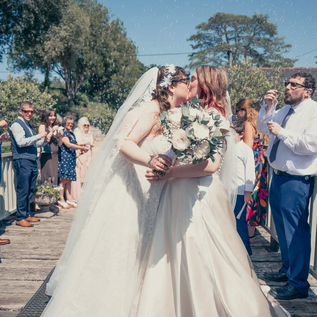 Two Brides with bubble confetti after their wedding at Sopley mill